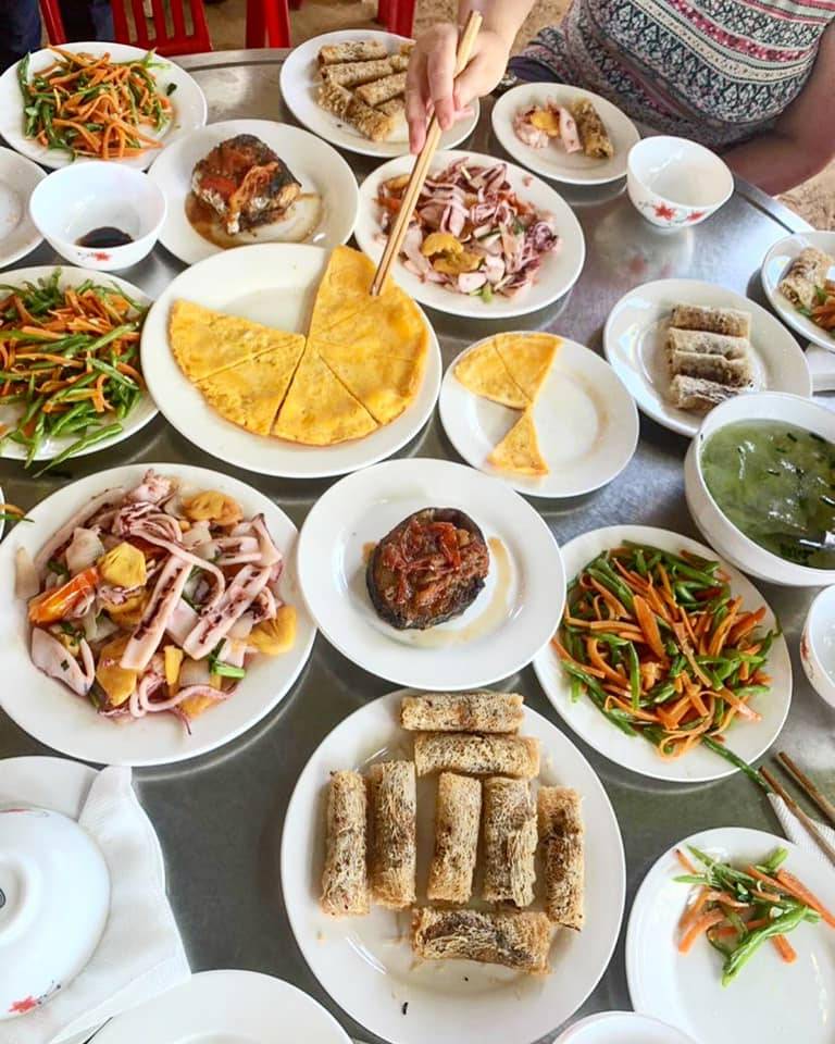 table full of plates of Vietnamese food